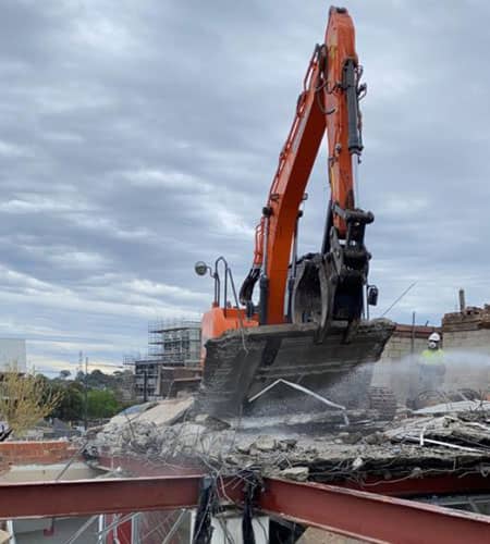 Heavy demolition equipment at a commercial site